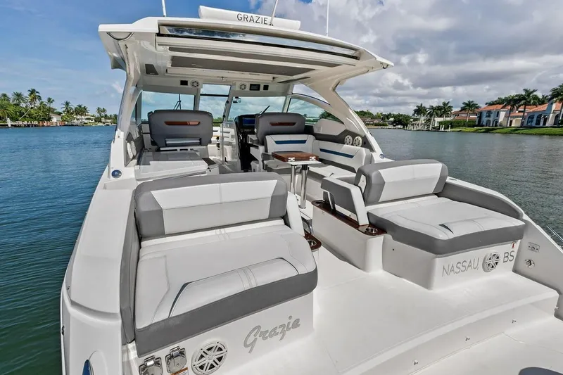 Slide: The Image of Luxurious 2020 Tiara 38 LX yacht with spacious seating on a serene waterfront. - 17