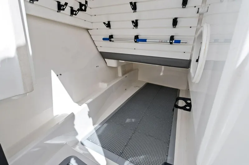 Slide: The Image of Interior view of 2020 Tiara 38 LX boat storage compartment with rod holders. - 29