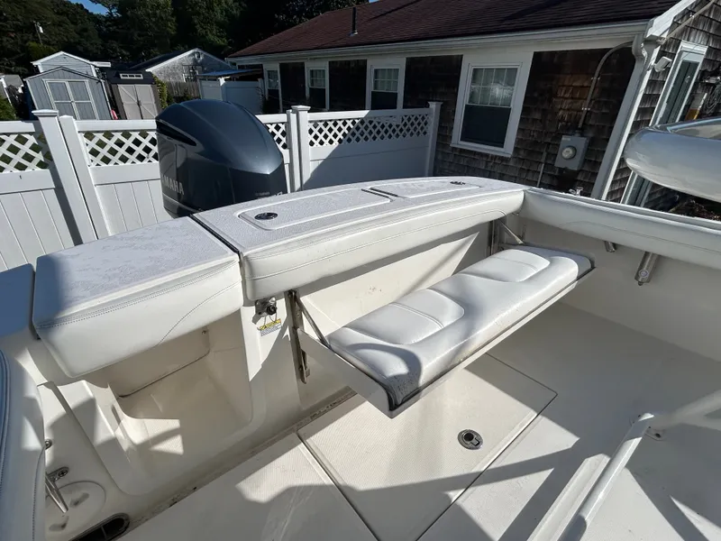 Slide: The Image of The image shows the cockpit of a 2020 Regulator 23 boat with white upholstery. - 23