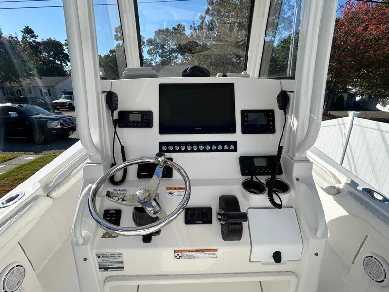 Slide: The Image of The image shows the helm of a 2020 Regulator 23 boat with modern instruments. - 20
