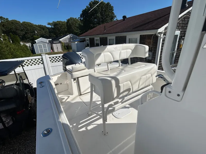 Slide: The Image of The image shows the cockpit of a 2020 Regulator 23 boat with white seating. - 17