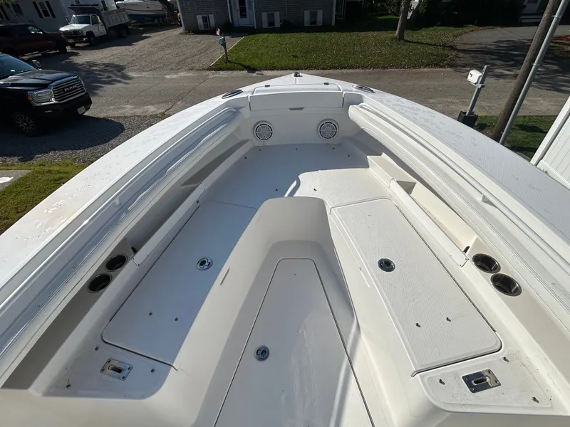 Slide: The Image of The image shows the bow of a 2020 Regulator 23 boat with seating and storage. - 15