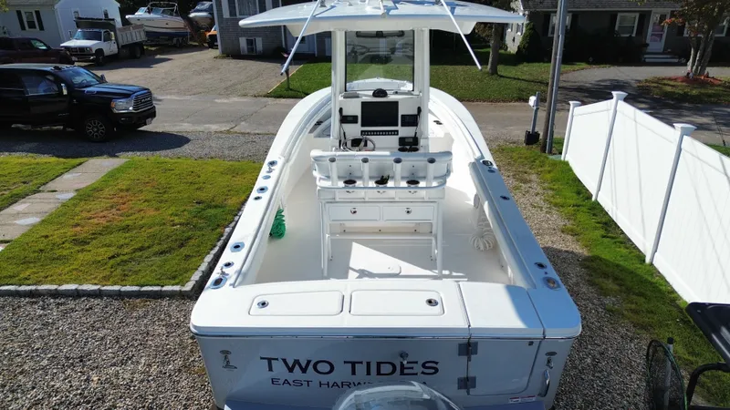 Slide: The Image of A 2020 Regulator 23 boat parked on a gravel driveway next to a white fence. - 13