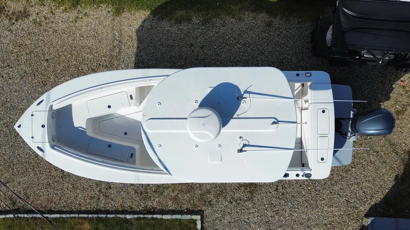 Slide: The Image of Aerial view of a 2020 Regulator 23 boat on a gravel surface. - 28