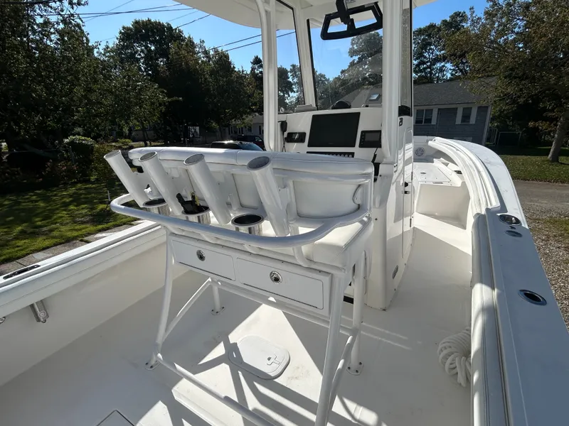 Slide: The Image of The image shows a white boat with a helm station and fishing rod holders. - 21