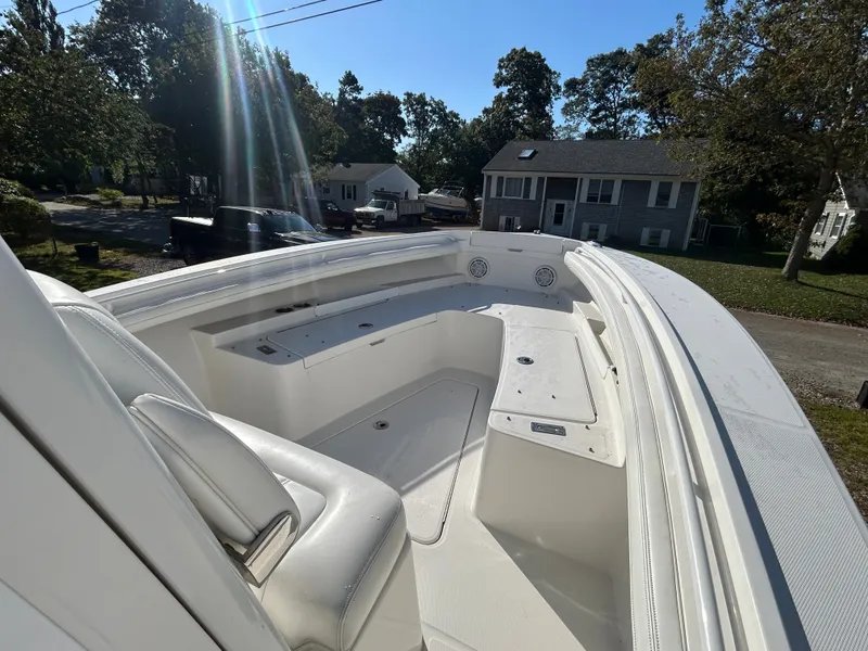 Slide: The Image of The image shows the bow of a 2020 Regulator 23 boat with white seating. - 14