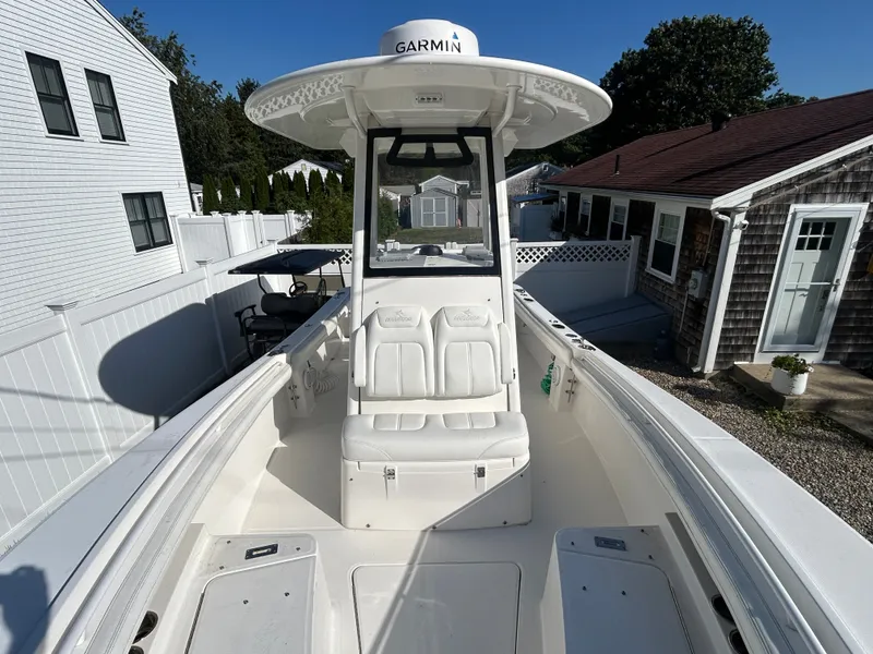 Slide: The Image of A 2020 Regulator 23 boat with a white deck and Garmin equipment. - 16