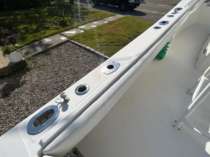 Slide: The Image of The image shows the deck of a 2020 Regulator 23 boat with fishing rod holders. - 25