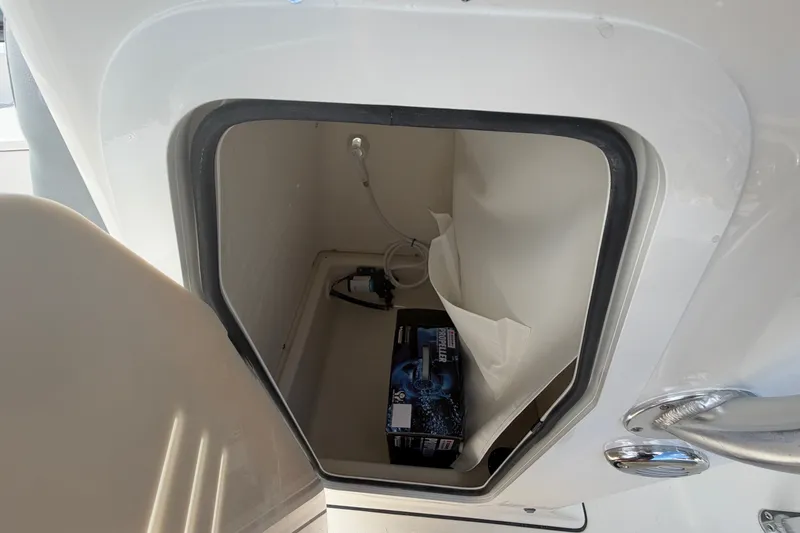 Slide: The Image of Storage compartment inside a 2027 Pioneer 220 Bay Sport boat, featuring a box and wiring. - 15