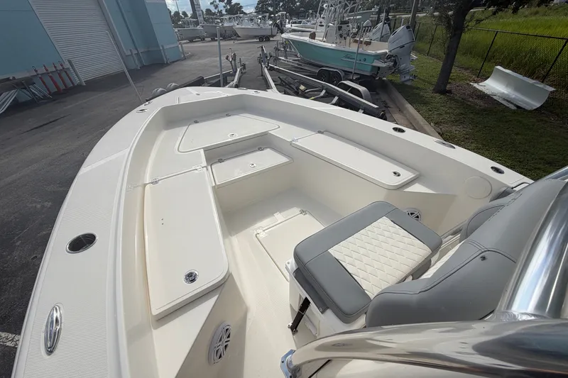 Slide: The Image of 2027 Pioneer 220 Bay Sport boat interior with seating and storage compartments. - 9