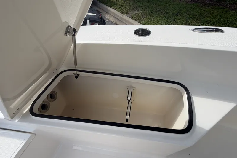 Slide: The Image of Open storage compartment on 2027 Pioneer 220 Bay Sport boat. - 13