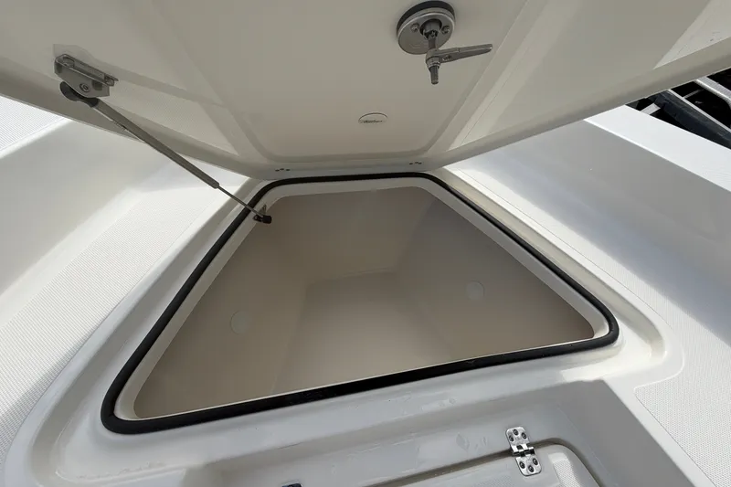 Slide: The Image of Open storage compartment on 2027 Pioneer 220 Bay Sport boat, showcasing spacious interior. - 11