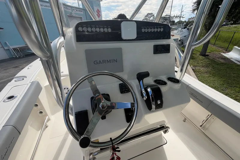 Slide: The Image of 2027 Pioneer 220 Bay Sport boat dashboard with Garmin navigation system and steering wheel. - 7