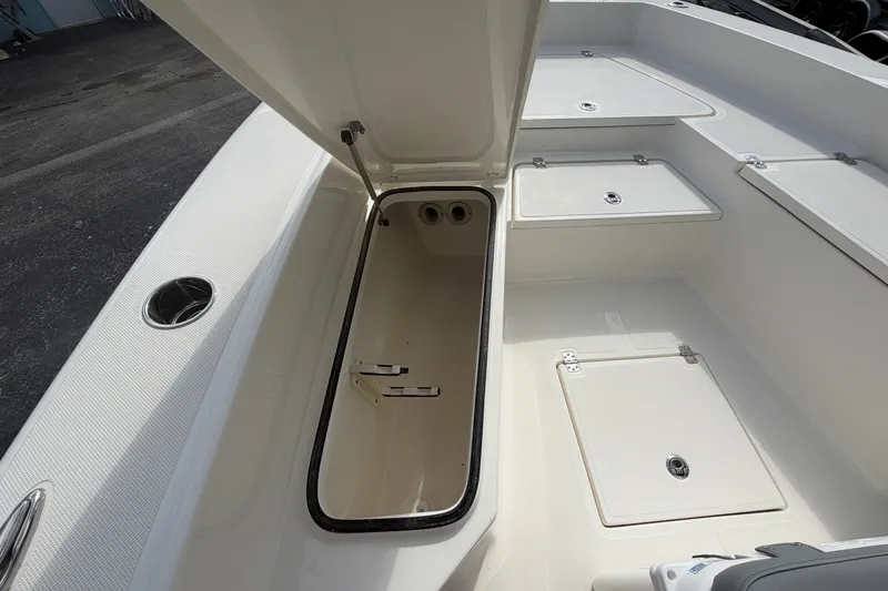Slide: The Image of 2027 Pioneer 220 Bay Sport boat interior with open storage compartments. - 10