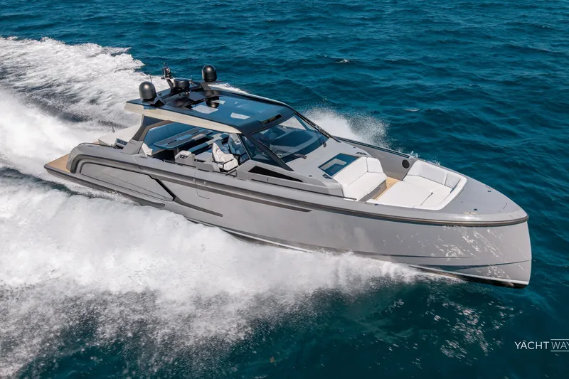 Slide: The Image of 2025 Vanquish Yachts VQ55 cruising swiftly on open blue waters. - 2