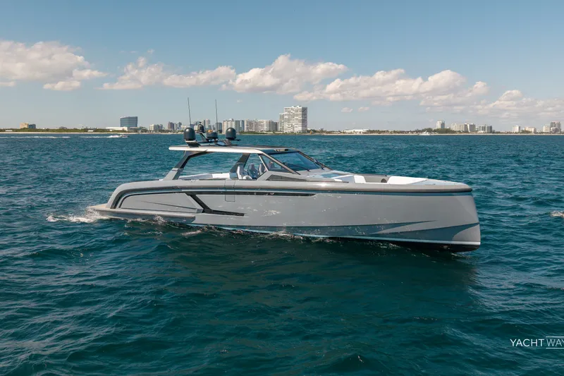 Slide: The Image of 2025 Vanquish Yachts VQ55 cruising on open water with city skyline in background. - 11