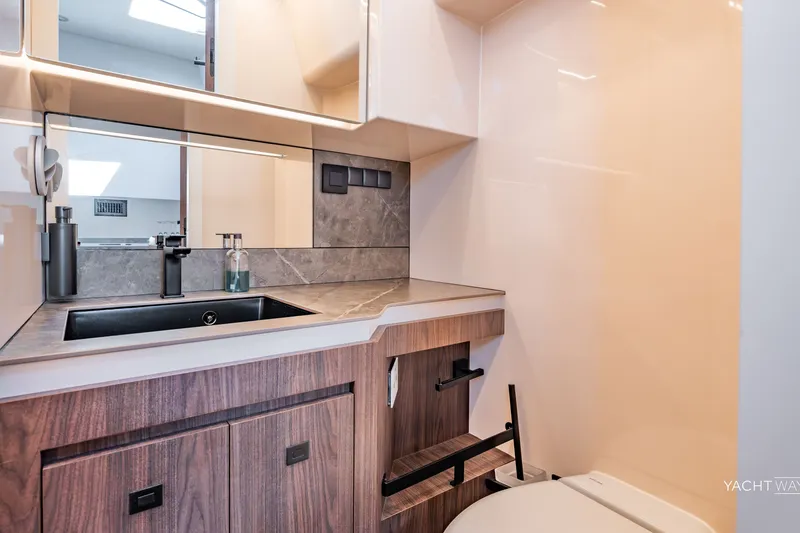 Slide: The Image of Luxurious bathroom interior of 2025 Vanquish Yachts VQ55, featuring modern sink and cabinetry. - 43