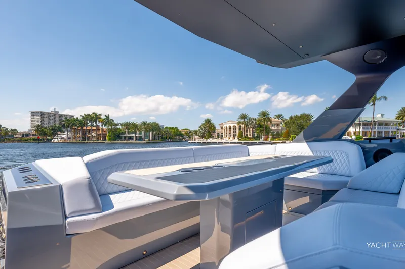 Slide: The Image of Luxurious 2025 Vanquish Yachts VQ55 with elegant seating and waterfront view. - 18