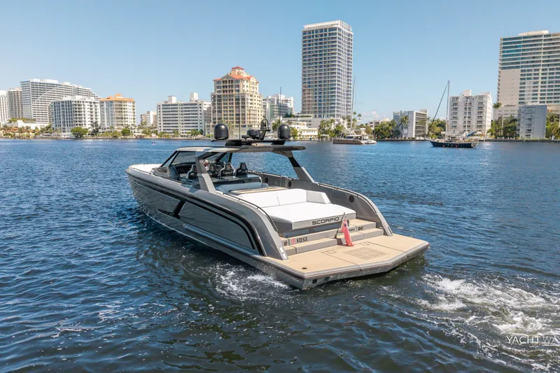 Slide: The Image of 2025 Vanquish Yachts VQ55 cruising in urban waterfront setting, modern buildings in background. - 16