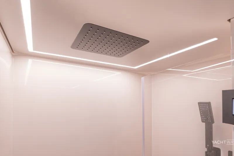 Slide: The Image of Luxurious shower area in 2025 Vanquish Yachts VQ55, featuring modern fixtures and ambient lighting. - 44