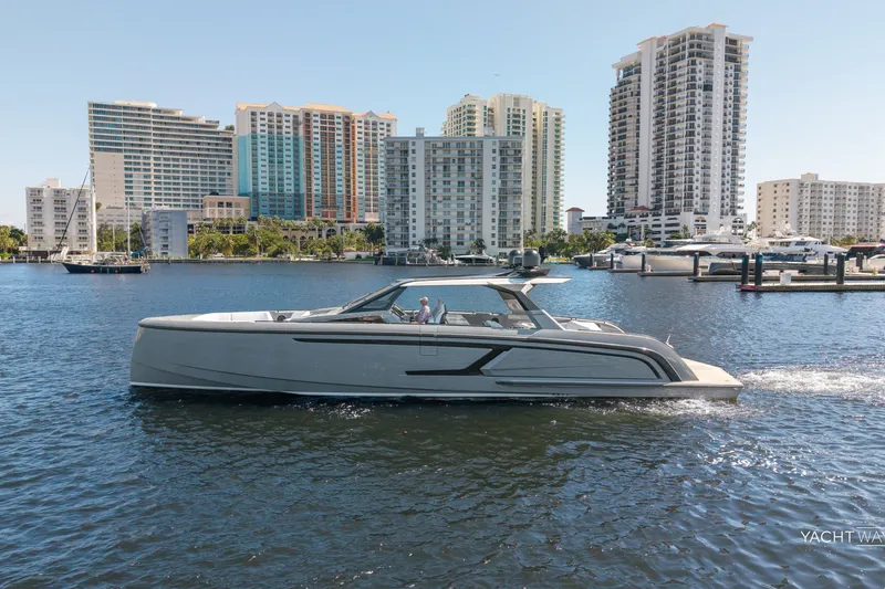 Slide: The Image of 2025 Vanquish Yachts VQ55 cruising in urban waterfront setting with skyscrapers. - 15