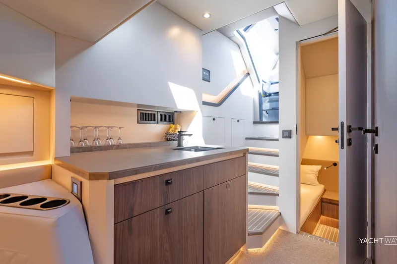 Slide: The Image of Luxurious interior of 2025 Vanquish Yachts VQ55, featuring modern kitchen and cozy cabin. - 37