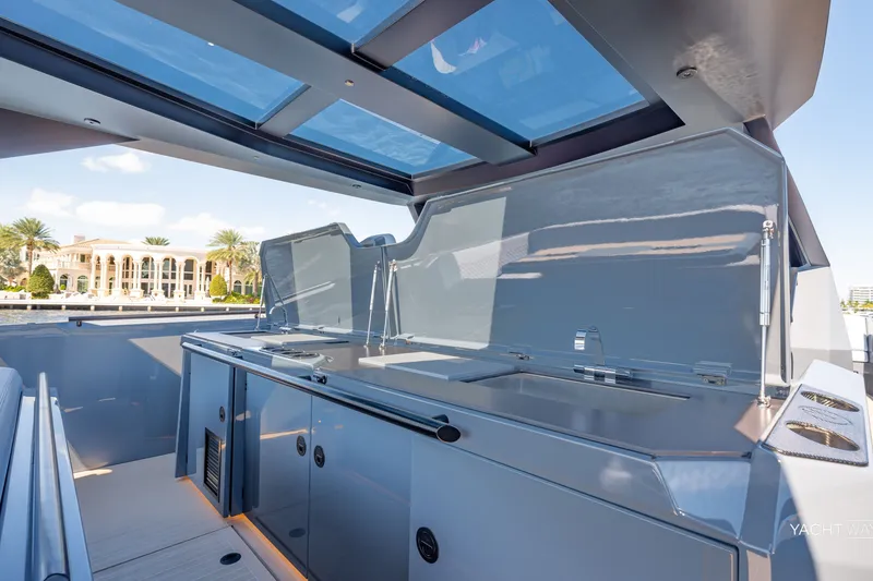 Slide: The Image of Luxurious 2025 Vanquish Yachts VQ55 with sleek outdoor kitchen and modern design. - 27