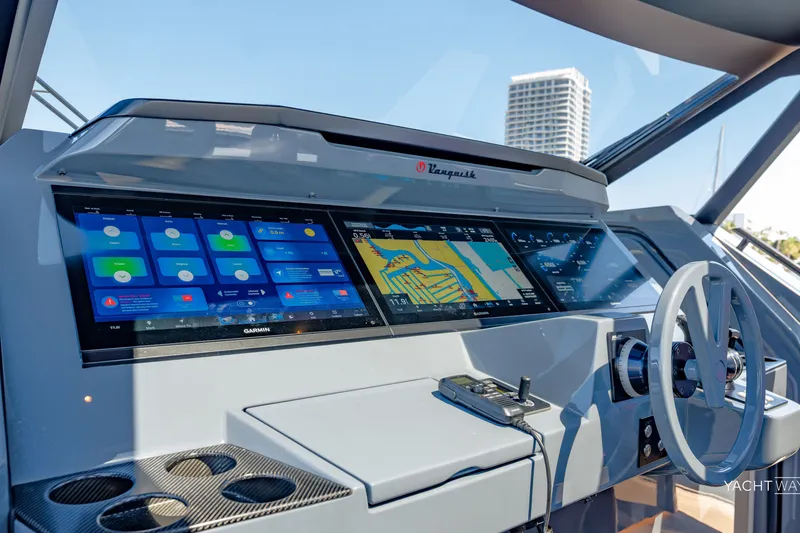 Slide: The Image of Cockpit of 2025 Vanquish Yachts VQ55 with advanced navigation displays and controls. - 33
