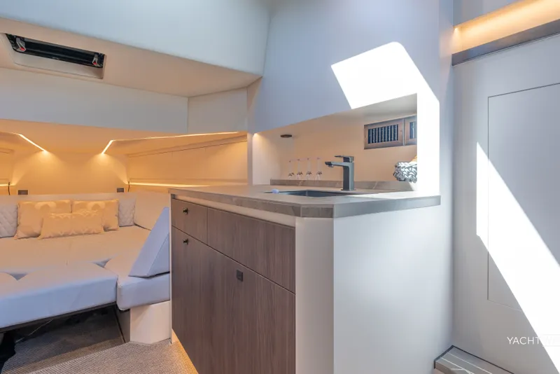 Slide: The Image of Luxurious interior of 2025 Vanquish Yachts VQ55, featuring modern kitchenette and cozy seating area. - 36