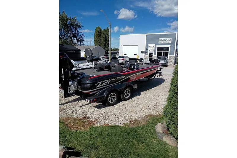 Slide: The Image of 2020 Nitro Z21 Pro boat parked outside a dealership on a sunny day. - 2