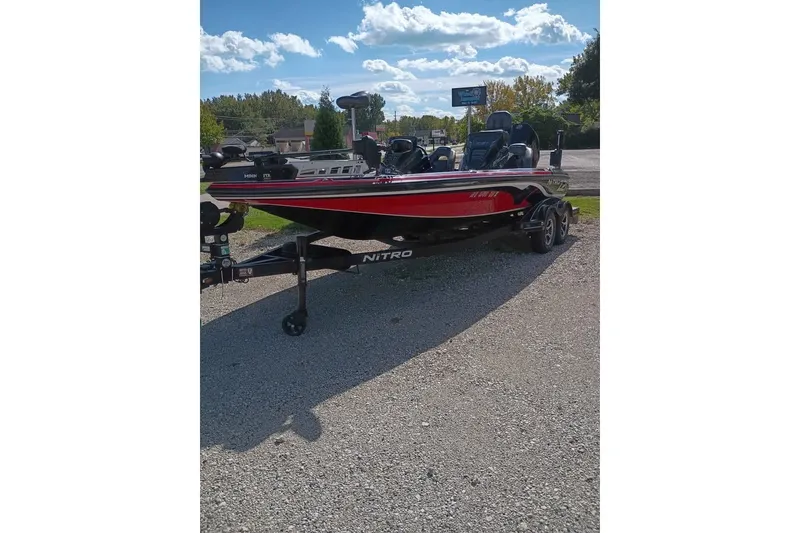 Slide: The Image of 2020 Nitro Z21 Pro bass boat on trailer under a sunny sky. - 1