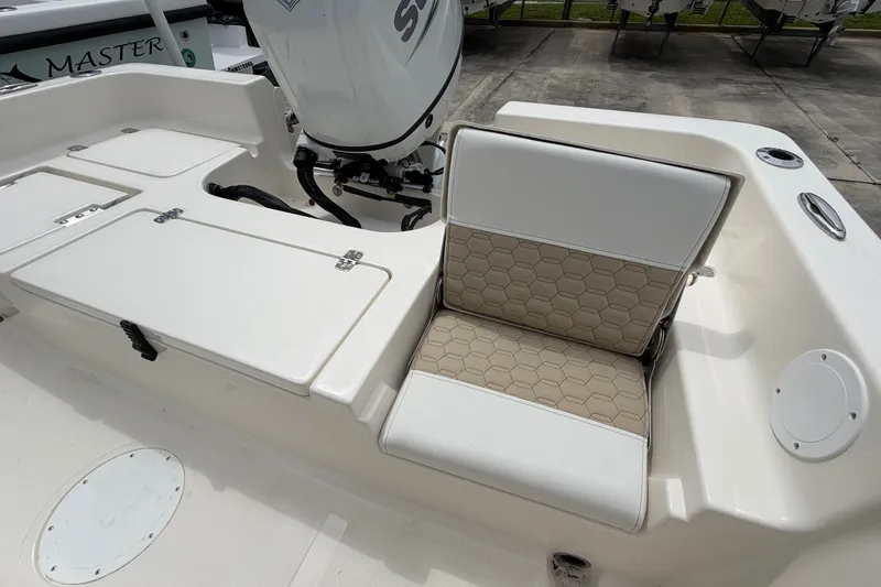Slide: The Image of 2027 Bulls Bay 2200 XS boat interior with cushioned seating and storage compartments. - 17