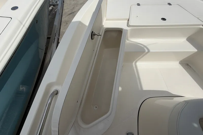 Slide: The Image of 2027 Bulls Bay 2200 XS boat interior with storage compartment and seating area. - 9