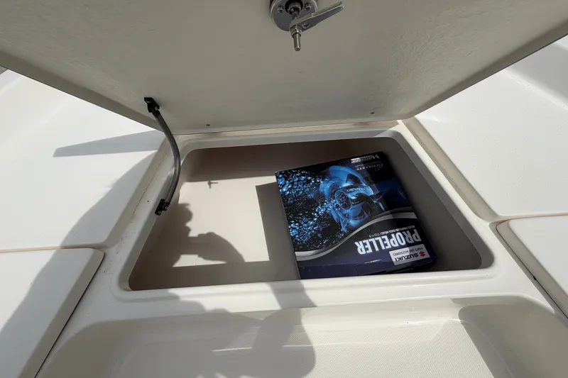 Slide: The Image of Open storage compartment on 2027 Bulls Bay 2200 XS boat with propeller box inside. - 10