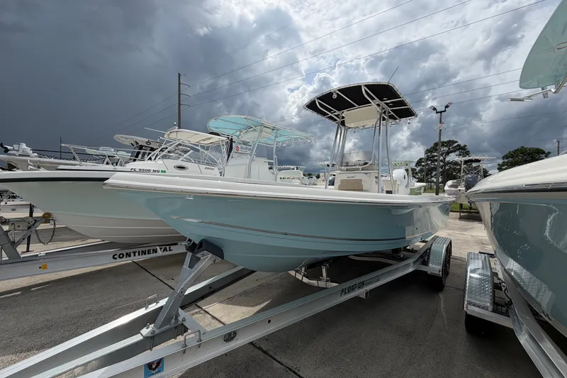 Slide: The Image of 2027 Bulls Bay 2200 XS boat on trailer under cloudy sky. - 2