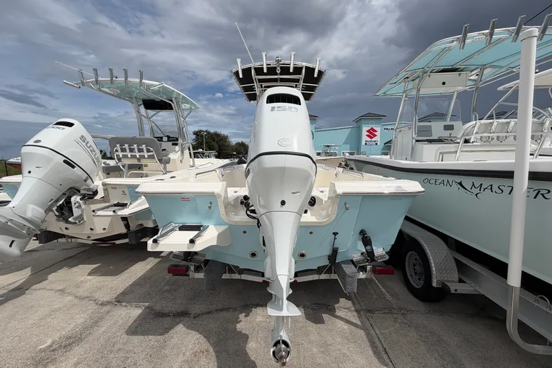Slide: The Image of 2027 Bulls Bay 2200 XS boat with powerful outboard motor, parked alongside other boats. - 4