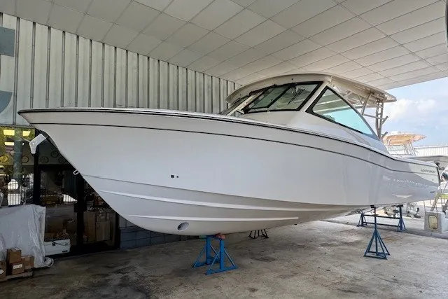 The Image of 2026 Grady-White Freedom 375 boat on stands in a covered storage area. - 1