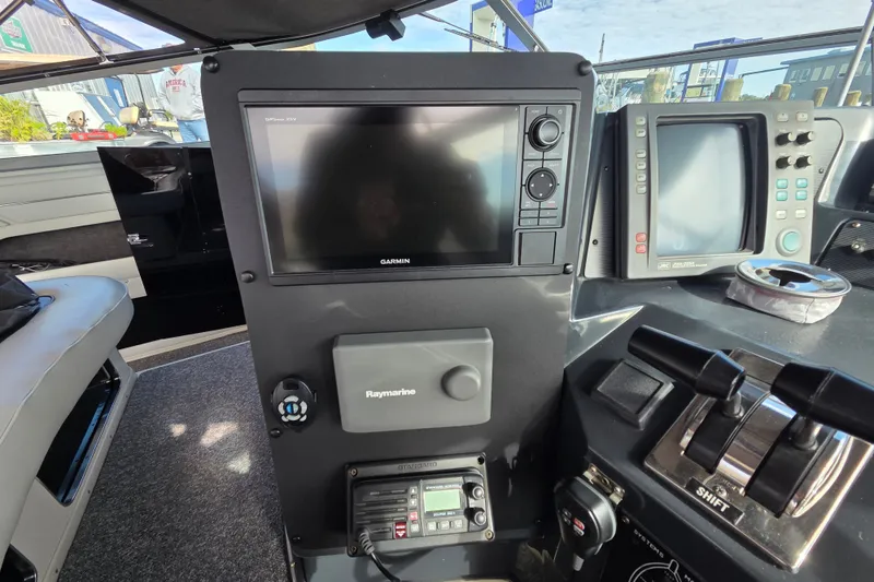 Slide: The Image of Control panel of a 1991 Sea Ray 420 Sundancer with Garmin and Raymarine electronics. - 18