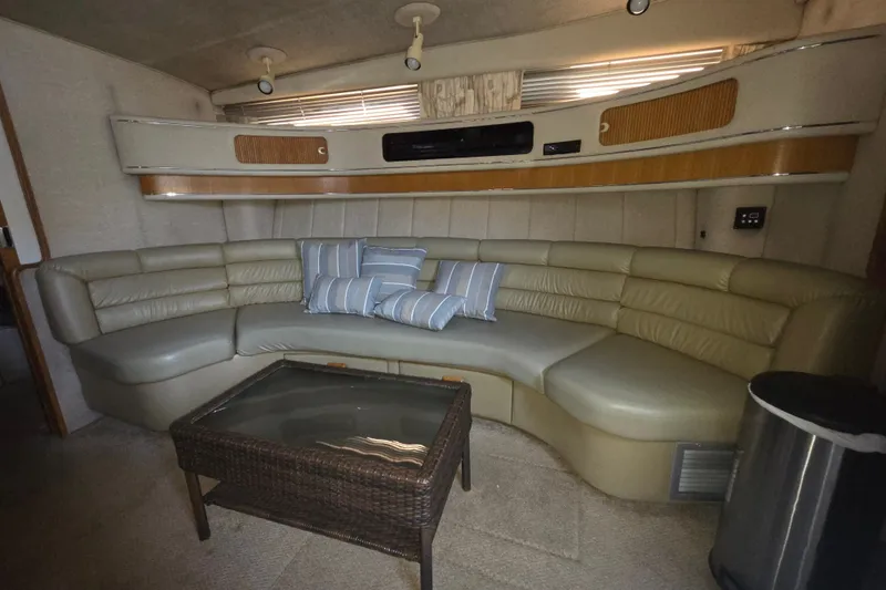 Slide: The Image of Luxurious interior of 1991 Sea Ray 420 Sundancer with curved leather seating and striped cushions. - 27
