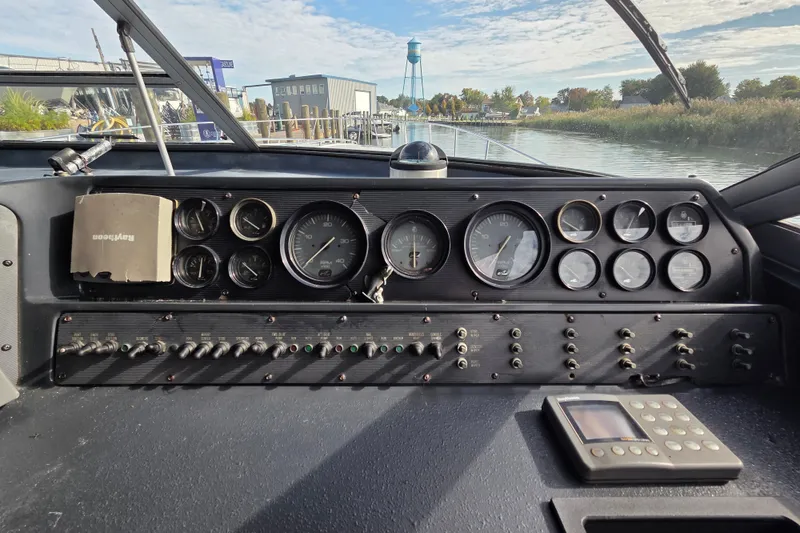 Slide: The Image of Control panel of a 1991 Sea Ray 420 Sundancer boat with gauges and switches. - 17