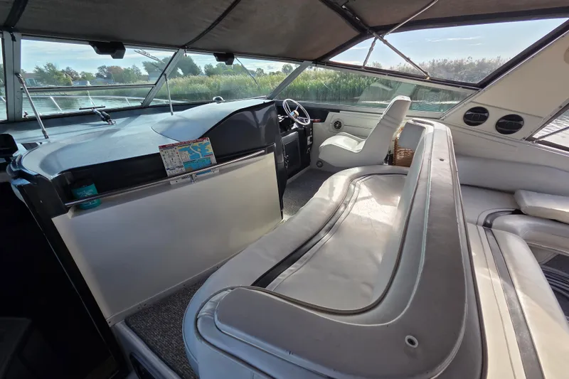 Slide: The Image of Interior of 1991 Sea Ray 420 Sundancer yacht with spacious seating and helm. - 13