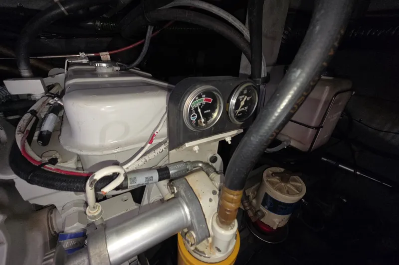 Slide: The Image of Engine compartment of a 1991 Sea Ray 420 Sundancer with gauges and hoses visible. - 29