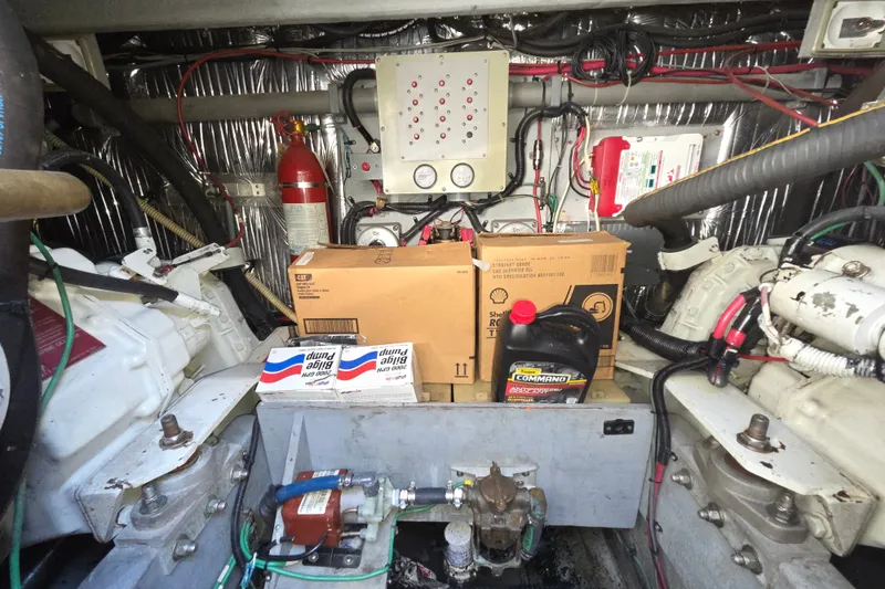 Slide: The Image of Engine room of a 1991 Sea Ray 420 Sundancer with maintenance supplies and equipment. - 33
