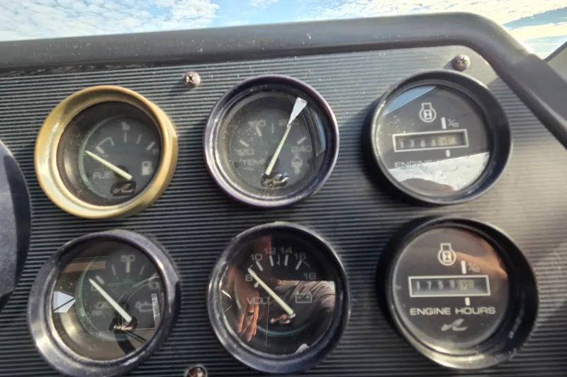 Slide: The Image of Dashboard gauges of a 1991 Sea Ray 420 Sundancer boat, showing fuel, temperature, and engine hours. - 16