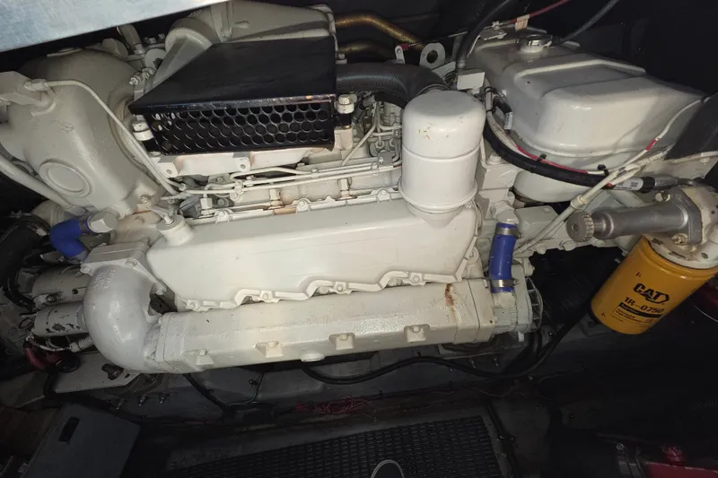 Slide: The Image of Engine compartment of a 1991 Sea Ray 420 Sundancer with visible components and CAT filter. - 28