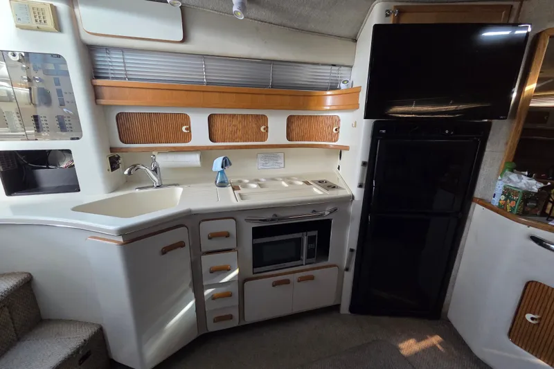 Slide: The Image of Interior of 1991 Sea Ray 420 Sundancer yacht kitchen with sink, microwave, and cabinets. - 22