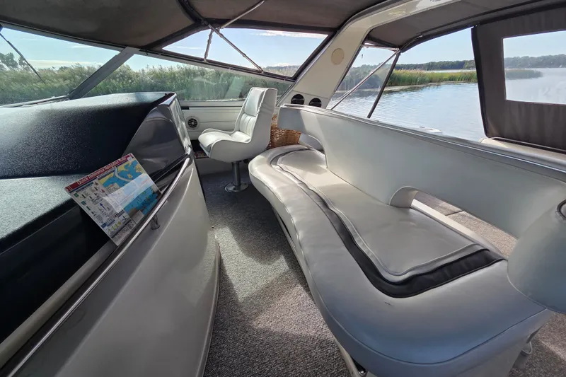Slide: The Image of Interior of 1991 Sea Ray 420 Sundancer yacht with seating and scenic water view. - 14