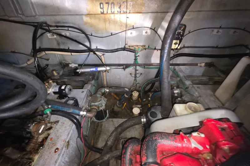 Slide: The Image of Engine room of a 1991 Sea Ray 420 Sundancer with visible hoses and components. - 34