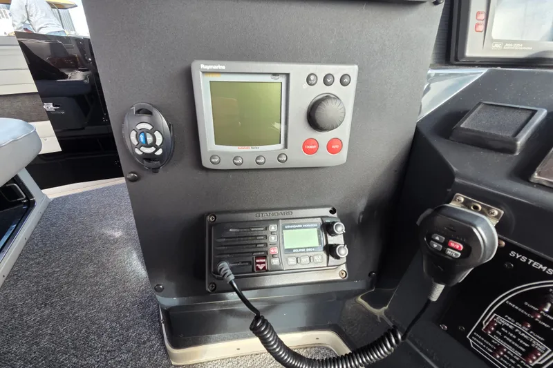 Slide: The Image of Control panel of a 1991 Sea Ray 420 Sundancer with navigation and communication equipment. - 19