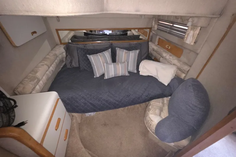 Slide: The Image of Cozy cabin interior of 1991 Sea Ray 420 Sundancer with plush bedding and cushions. - 25